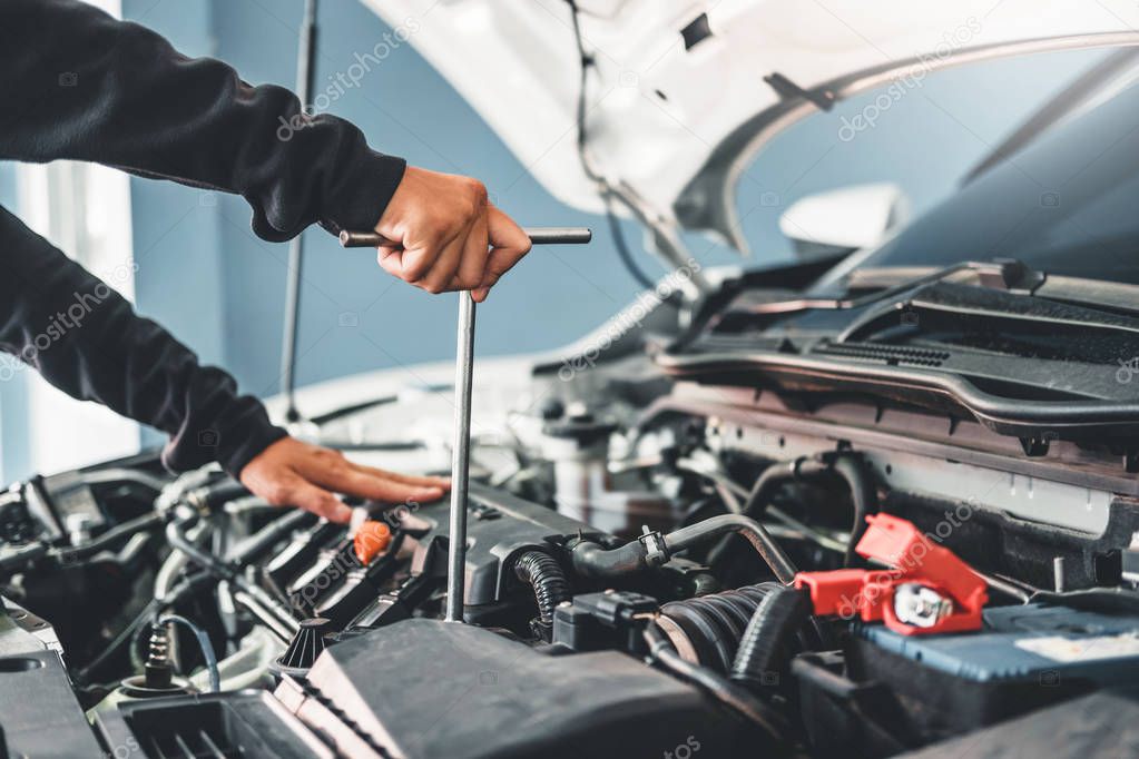 Technician Hands of car mechanic working in auto repair Service 