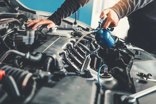 Technician Hands of car mechanic working in auto repair Service