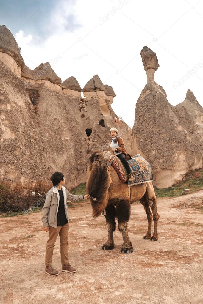 Traveler couple with camel at Goreme fairy chimneys , Cappadocia