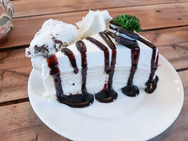 Crape cake with chocolate sauce and icecream on plate — Stock Photo, Image