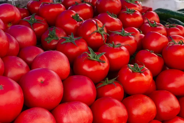 Tomatoes on the market. Ripe big tomatoes closeup.