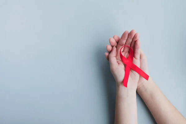 Womans Hands Hold Red Ribbon Awareness Aids Light Blue Background — Stock Photo, Image