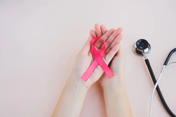 Womans Hands Hold Pink Breast Cancer Awareness Ribbon Light Background — Stock Photo, Image