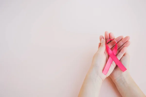 Womans Hands Hold Pink Breast Cancer Awareness Ribbon Light Background — Stock Photo, Image