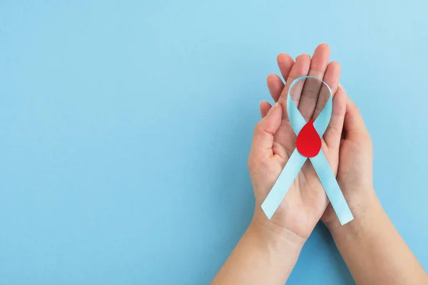 Womans Hands Hold Light Blue Ribbon Awareness Red Blood Drop — Stock Photo, Image