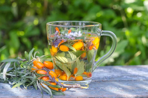 Herbal tea with lemon balm and sea buckthorn in the sun. healthy lifestyle