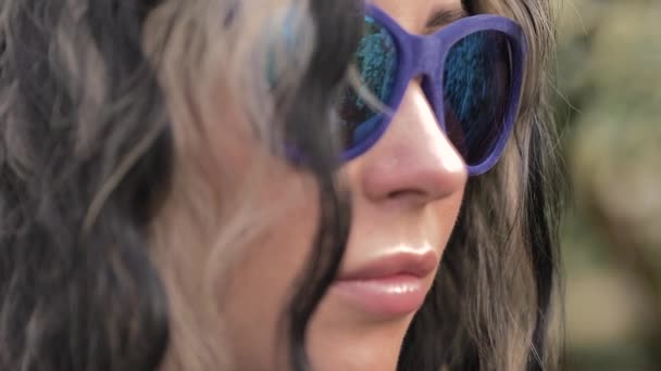 Portrait of a girls face in blue mirror glasses — Stock Video