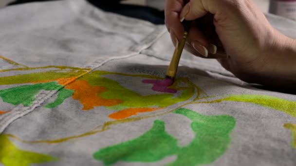 Female Hand Applies Pink Paint Fabric Pattern Using Brush — Stock Video