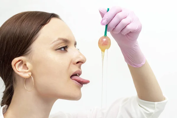 Depilation master girl shugaring girl dipped lollipop in sugar paste for depilation