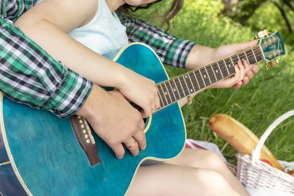 summer picnic guy teaches girl to play the guitar love warm tenderness