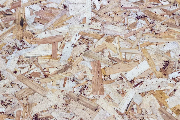 wood texture background. pressed sawdust. OSB boards are made of wood chips. Top view of OSB wood veneer background