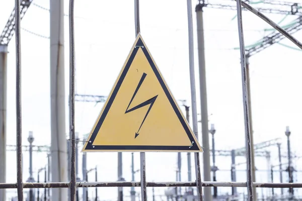 High Voltage Sign and Symbol Caution Signboard on Fence Wire at Electrical Power Plant Station