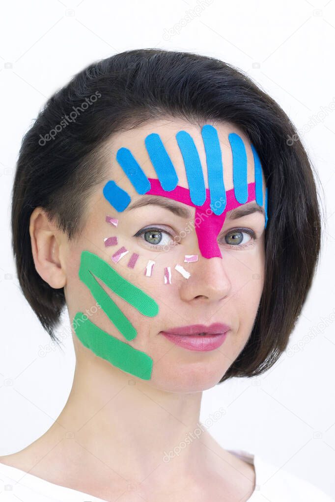 Face taping, close-up of a girls face with cosmetological anti-wrinkle tape. Face aesthetic taping. Non-invasive anti-aging lifting method for reduction of wrinkles. vertical photo