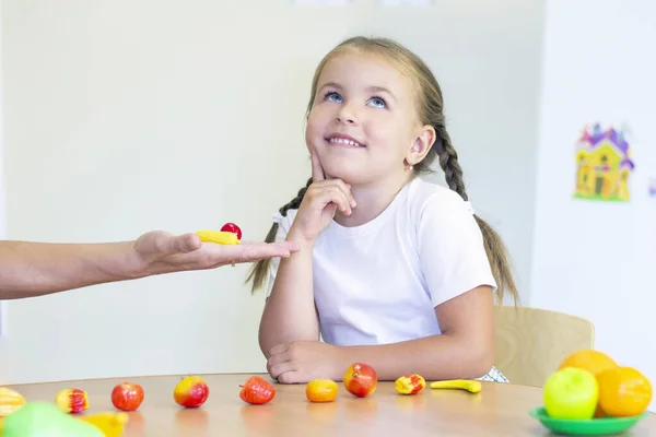 developmental and speech therapy classes with a child-girl. Speech therapy exercises and counting games. the girl thought