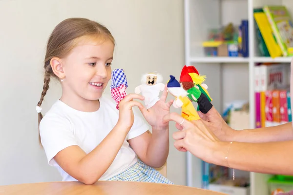 developmental and speech therapy classes with a child-girl. Speech therapy exercises and finger theater games.