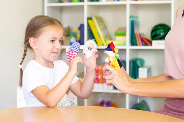 developmental and speech therapy classes with a child-girl. Speech therapy exercises and finger theater games.