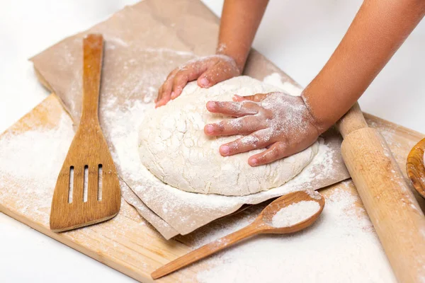 stock image dough in flour kneading childrens hands, one kid, child helps parents in kitchen, concept of a happy childhood, household help, homework, food preparation