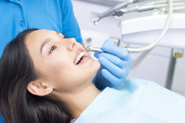 Dentist and patient in the dental office. Woman having teeth examined by dentists