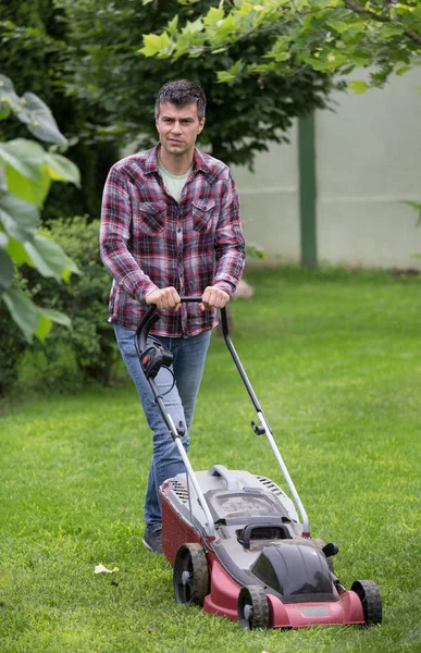 Handsome Young Man Trimming Grass Electric Mower Backyard Spring — Stock Photo, Image