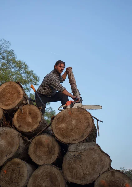 Young Strong Lumberjack Chainsaw Working Wooden Logs Pile — Stock Photo, Image