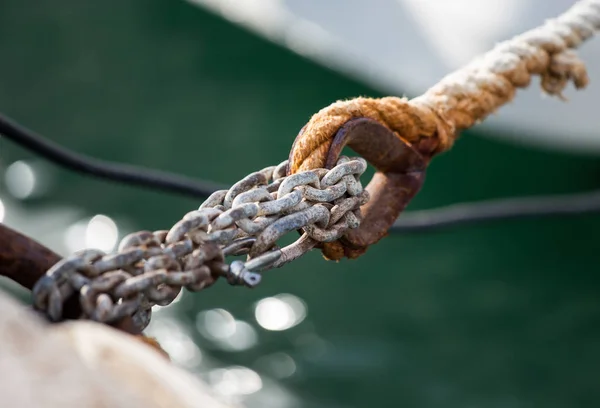 Close up of boat chains tied at dock