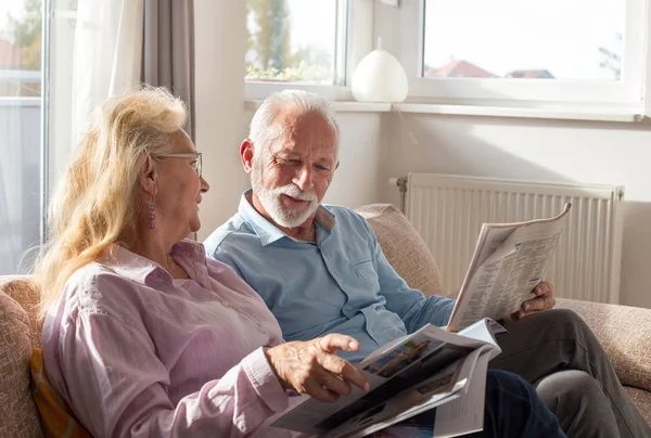 Senior Couple Reading Newspaper Magazine Sofa Home — Stock Photo, Image