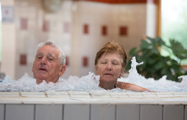 Elderly Couple Enjoying Indoor Pool Hot Water Spa Resort — Stock Photo, Image