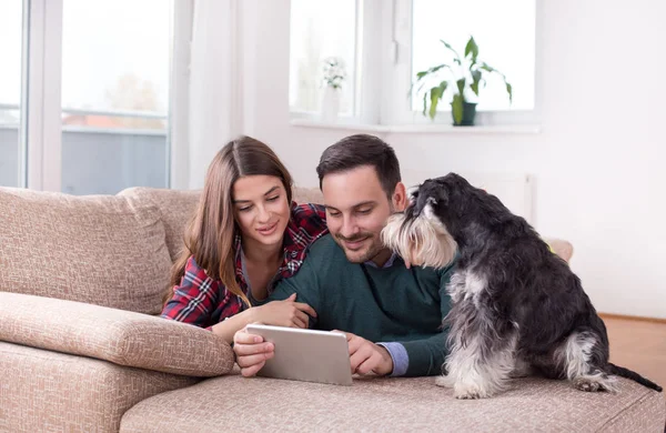 강아지 소파에 부부와 태블릿을 — 스톡 사진