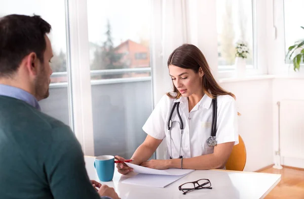 Médico e paciente conversando à mesa — Fotografia de Stock