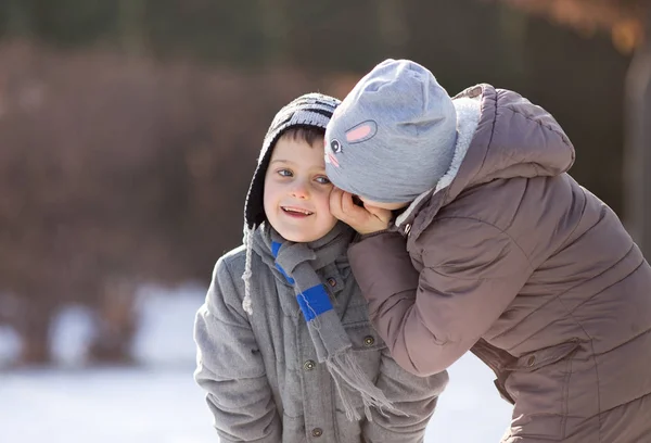 Děti si hrají a šeptají na sněhu — Stock fotografie