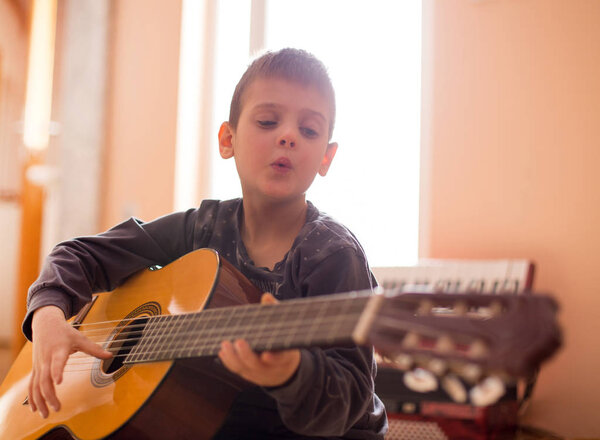 Boy enjoying playing guitar