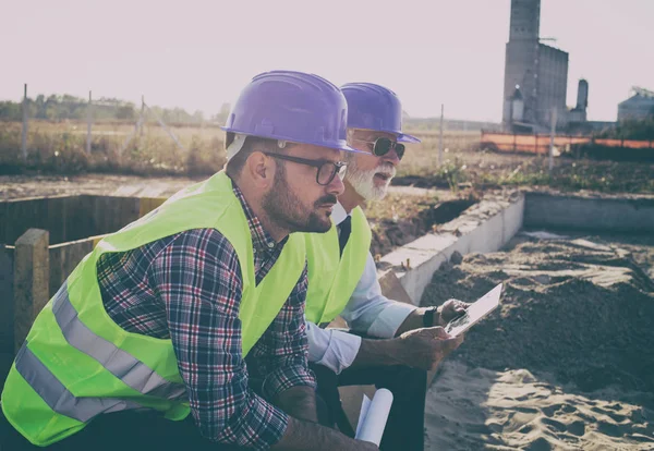 Engenheiro sentado no canteiro de obras e pensando — Fotografia de Stock