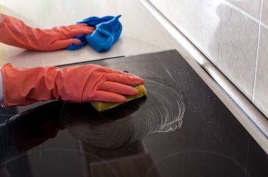 Mutfakta kadın temizlik sobası.