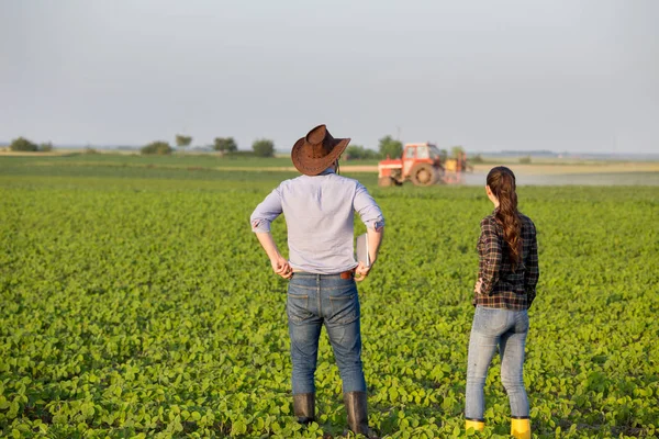 Agricultores delante del tractor en el campo —  Fotos de Stock