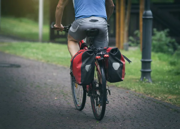 Man riding bike with rear seat bags — Stock Photo, Image