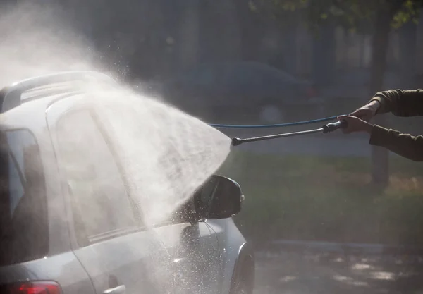 Manual car washing with high pressured water — Stock Photo, Image