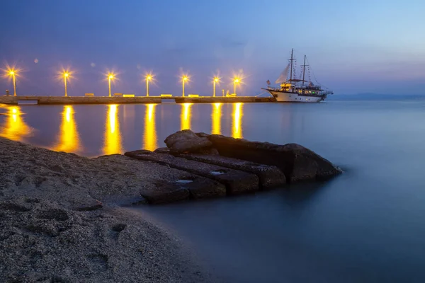 Amazing sunrise with stone and pier from Pefkochori — Stock Photo, Image
