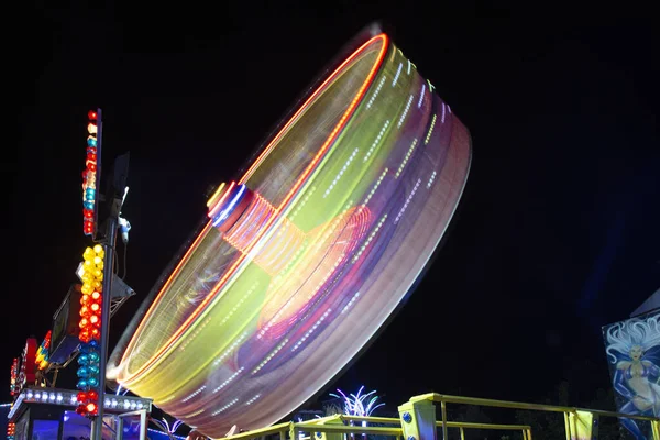 Centrifuge ferris wheel moving at night — Stock Photo, Image