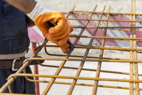 Tightening wire on rebar using a pincers — Stock Photo, Image