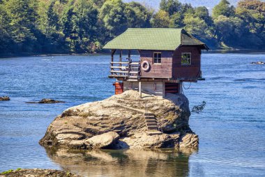 House on Drina in Bajina Basta, Serbia. Drina river with famous house on the stone.  clipart