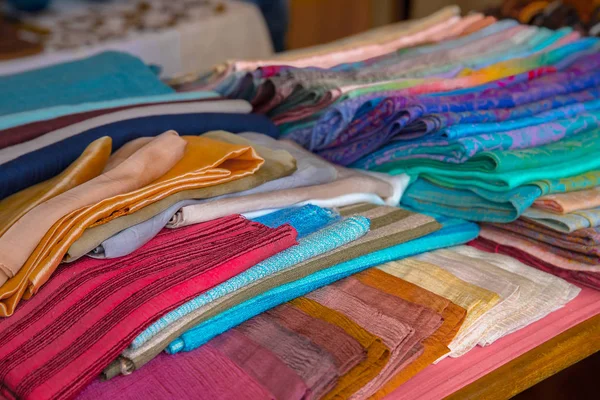 Pañuelos tejidos de colores sobre la mesa en la exposición . — Foto de Stock