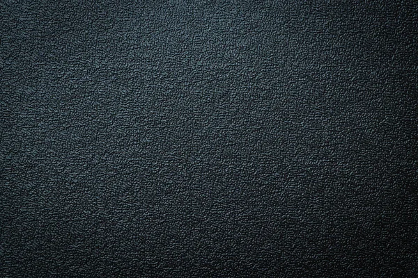 Close-up of black gray plastic material seamless texture. Surface of rough abstract dark black matte background. Design in your work backdrop, concept copy space for text.