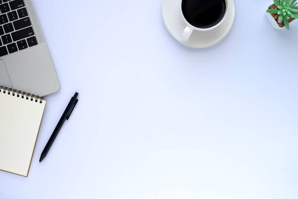 Top view above of White office desk table with laptop, notebook and coffee cup with equipment other office supplies. Business and finance concept. Workplace, Flat lay with blank copy space.