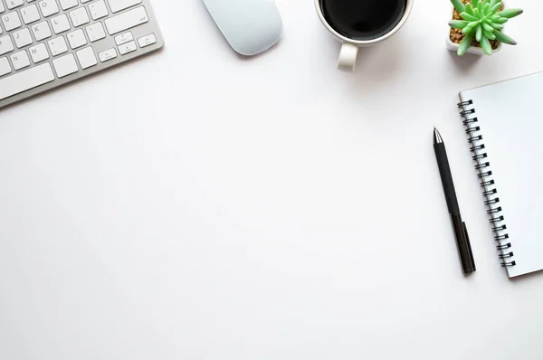 Top view above of White office desk table with keyboard, notebook and coffee cup with equipment other office supplies. Business and finance concept. Workplace, Flat lay with blank copy space.