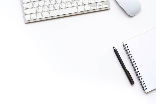 Top view above of White office desk table with keyboard, notebook and pen with equipment other office supplies. Business and finance concept. Workplace, Flat lay with blank copy space.