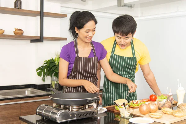 Happy family. Asian lovely couple, beautiful woman and handsome man is preparing ingredients and cooking food for having breakfast in the kitchen