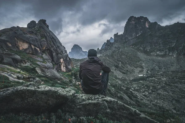 Man sitting alone in the mountains, freedom