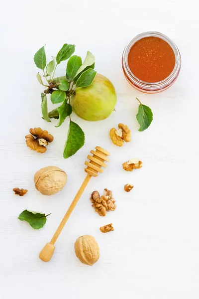 Stock image Honey, apples and walnuts on white wooden background. Overhead food shots. Copy space composition