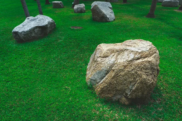 Stones Chair On Green Grass In The Garden Design