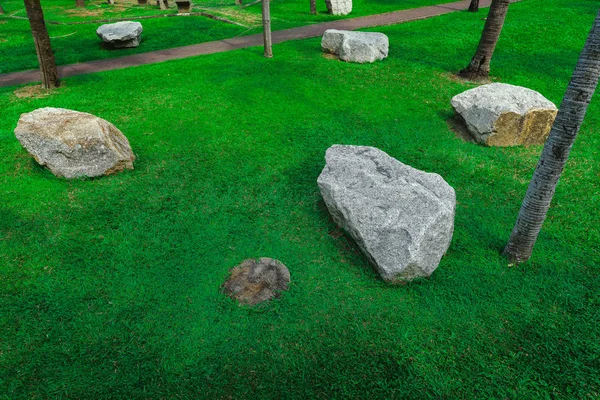 Stones Chair On Green Grass In The Garden Design